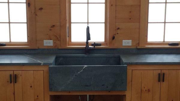 Soapstone countertops with a custom apron front sink