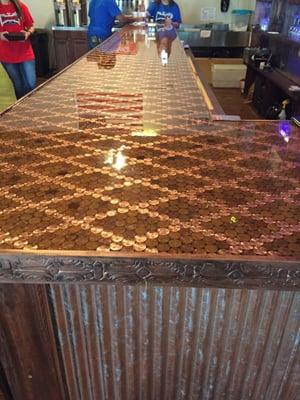 A must see!!! The bar top is made of all pennies. Each penny was laid by hand on heads -- take a wild guess on how many pennies!!