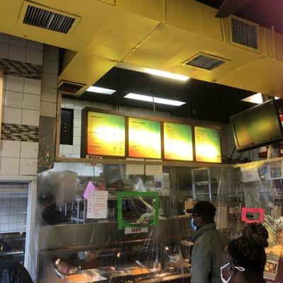 The customers were social distancing and the food is served through a plastic divider. You can't really see the menu.