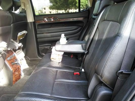 Black luxurious interior with complimentary phone charger and bottle water standard.