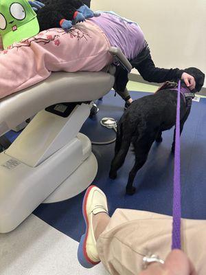 Olivia with her service dog getting a cleaning at the best place around.