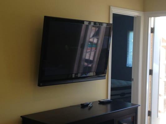 42" SmartTV mounted in bedroom with concealed wiring/cables.