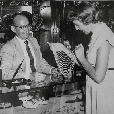 Bob Lewis helping a customer c. 1950's