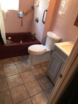 Fix rotted floor, remove old tile, toilet and vanity and tile floor, install new toilet and vanity