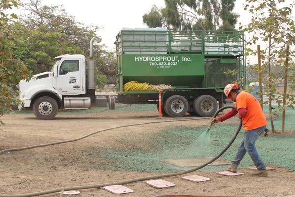 Carefully spraying around concrete for a crisp, clean application at a park in Los Angeles County