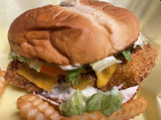 Golden Fried Catfish Sandwich on a toasted brioche bun with tarter sauce, lettuce, tomatoes, onions, w/fries