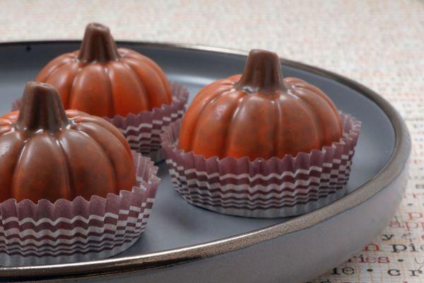 Pumpkin Truffles in milk chocolate and pumpkin spice ganache center.