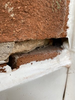 Chimney with visible cracks and missing mortar