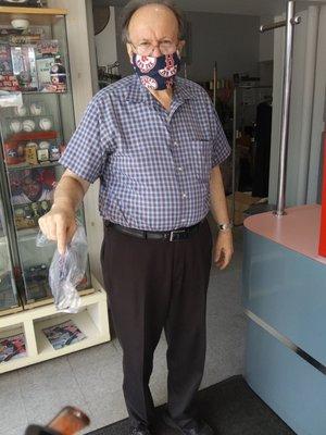 Adam the owner handing me a Red Sox mask.