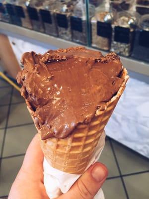 Dark chocolate peanut butter ice cream with a waffle cone