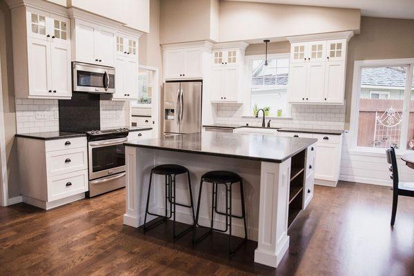 Bright cabinets contrast beautifully with dark granite and hardwood flooring!