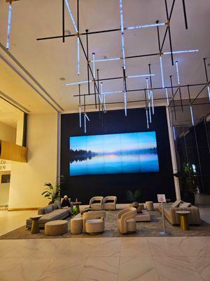 TV screen and seating area in lobby