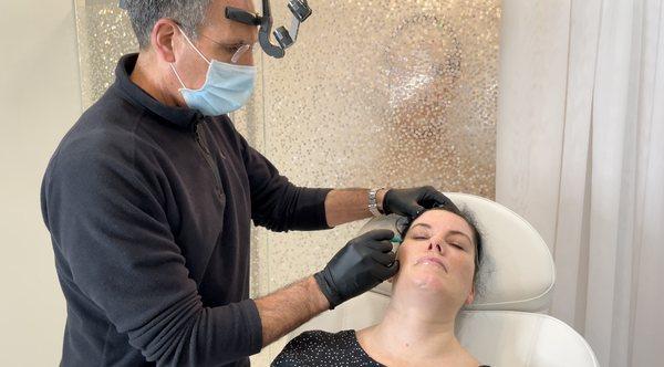 Dr. Castelli injecting our esthetician, Shannon with dermal filler.