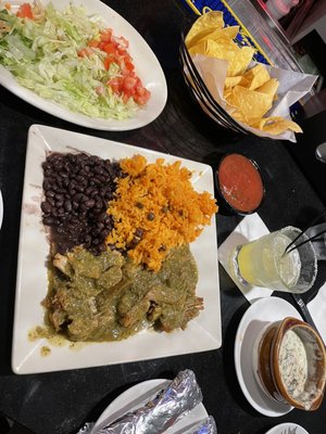 Carnitas verde with side of lettuce and tomato with bowl of espinaca