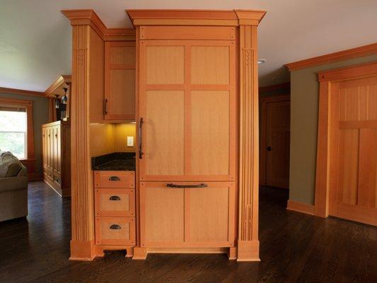 Former desk area converted to built in refer. Overlay wood detailing on faux posts.