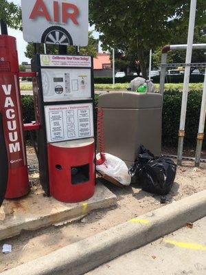 No sign Broken air machine and overflow piles of trash in can