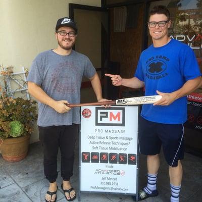 Pro baseball player Scott Heineman gifting Pro Massage his signed bat to thank Jeff for all of the work he's done for him over the years.