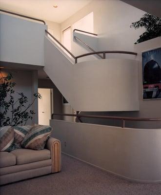 A curved stair connects a new second floor and loft as part of this residential remodel, Manhattan Beach, CA