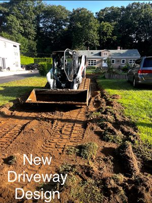 Excavation of a grass area to create a new asphalt driveway.