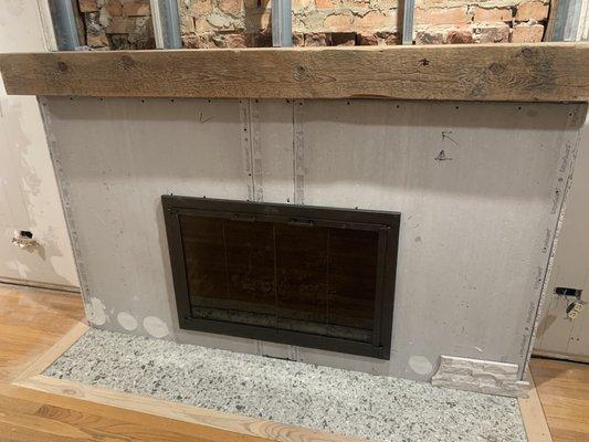 Unfinished fireplace. We did the floor ourselves. Guess we'll be finishing it once we find new stone.