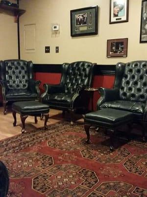 Part of the non-member lounge high back leather chairs ottomans large screen TV for your enjoyment