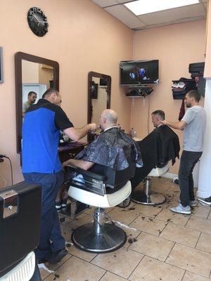 Barbers cutting hair