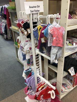 American Girl doll clothes and empty hangers below