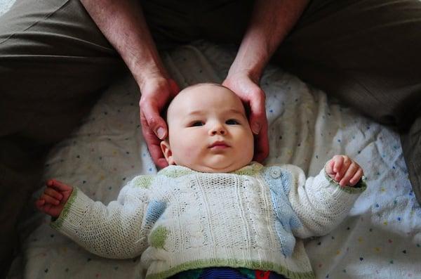 Performing CranioSacral Therapy (CST) on a baby.