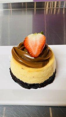 Mini chocoflan with cajeta and strawberry on top.