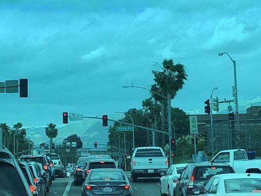 Snow capped mountains, windy day with traffic in Alhambra.