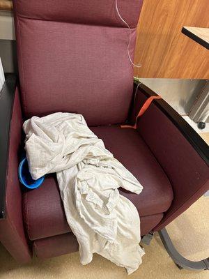 Throw up bag, old IV, dirty blanket on the chair next to me.