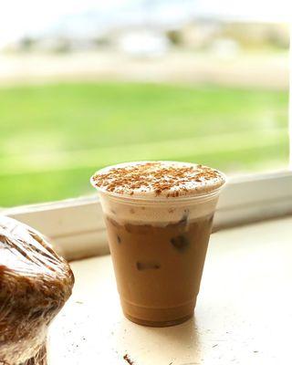 Iced americano with cold foam and dusted cinnamon