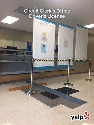 Just like the old location, you still have to wait while they develop your drivers license.