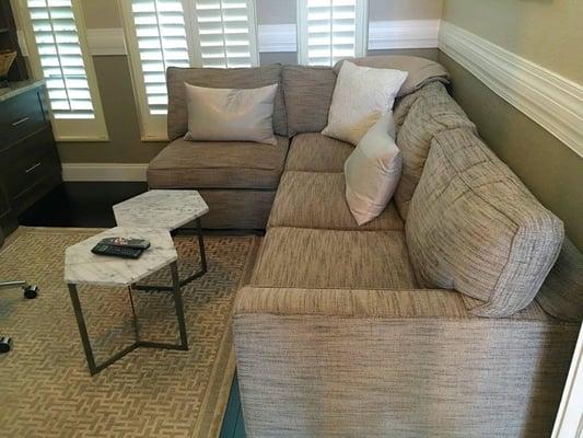 Custom couch with chenille fabric, custom pillows and marble table.