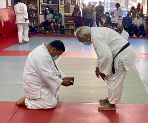 Ivan receiving his black belt promotion.