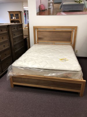 Queen bed frame with drawer storage in display room