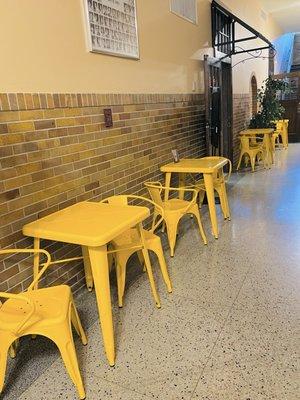 Cute yellow tables and chairs outside there diner entrance