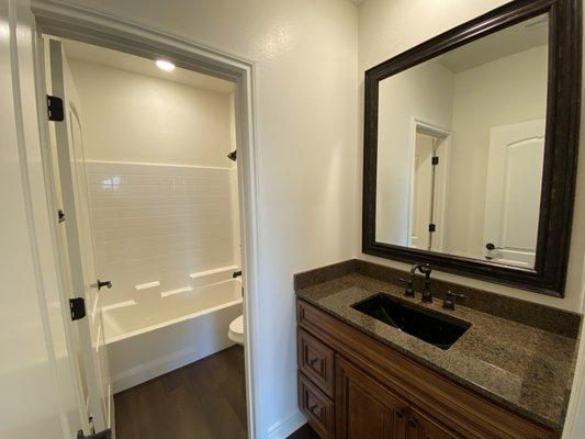 Oil rubbed bronze plumbing fixtures and mirrors with black sinks.