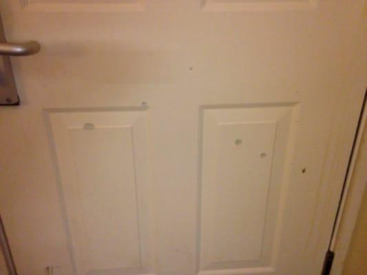 BB gun holes on the inside of the room door.