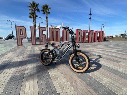 Moped style electric bike with fat tires for beach cruising