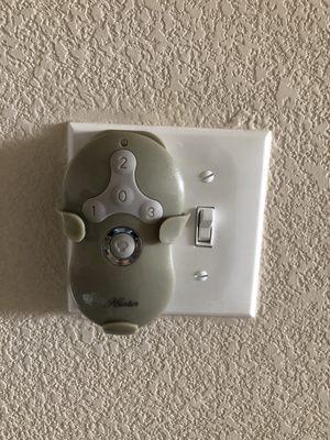 Wireless Fan remote mounted on wall.