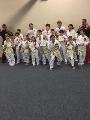 Students happy to receive their new belts after their first evaluation!