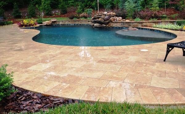 "Noce Premium" Stone Travertine Pool Decking & Coping featured on this custom poolscape.