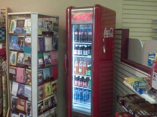 Retro coca-cola machine in the store and unique cards/gifts