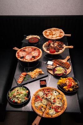 Various Pizzas and Mixed Grill and salads with appetizers