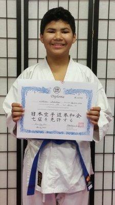 One of our proud teenagers earning his blue belt!