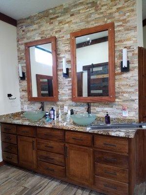 Custom made double vanities, picture frames and stone backsplash to ceiling height.