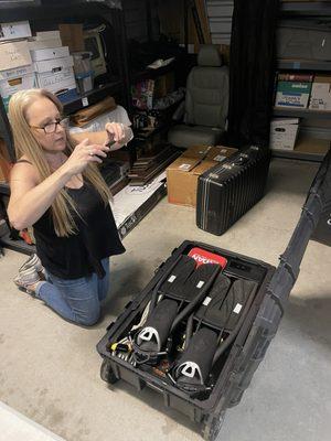 Kate photographs what's in a storage container of scuba equipment