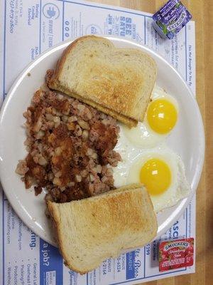 Cornned beef hash, two eggs sunny side up, and sourdough toast