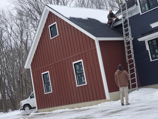 Installing new siding on a house in Derry, NH